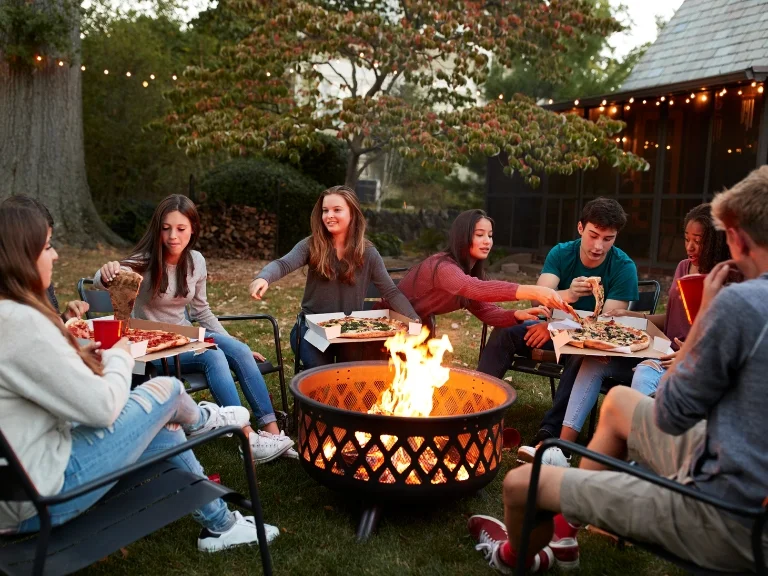 A group of friends eating some meals in outdoor kitchen